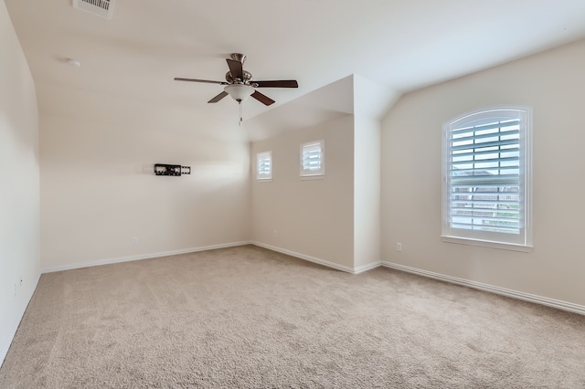 carpeted empty room with ceiling fan and lofted ceiling