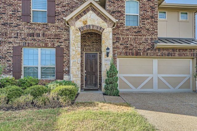 view of exterior entry with a garage