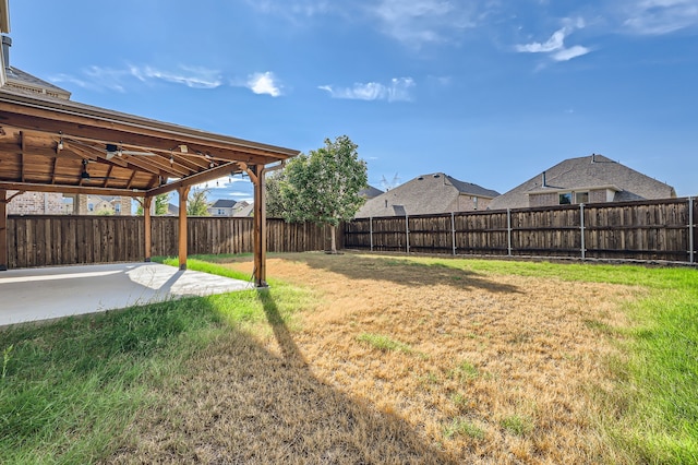 view of yard featuring ceiling fan and a patio area