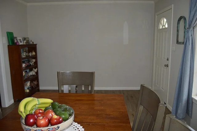 dining room with hardwood / wood-style floors and ornamental molding