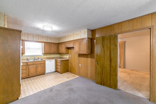 kitchen with light carpet, a textured ceiling, dishwasher, sink, and decorative backsplash