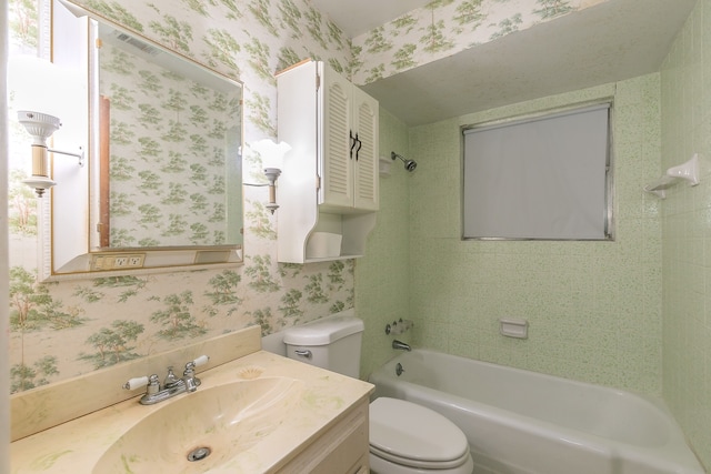 full bathroom with tiled shower / bath combo, vanity, and toilet