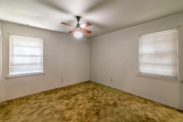 carpeted empty room featuring ceiling fan