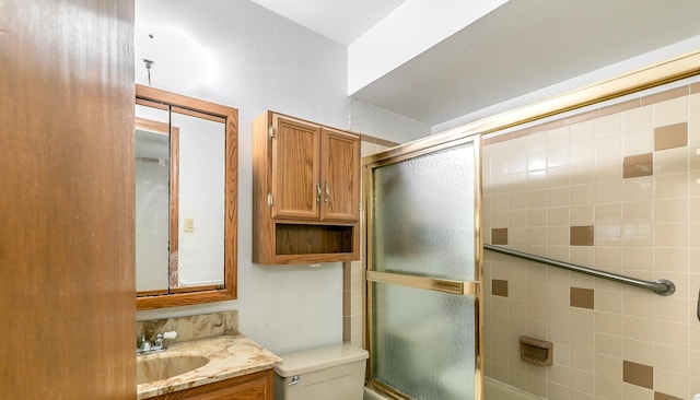 bathroom featuring vanity, toilet, and walk in shower