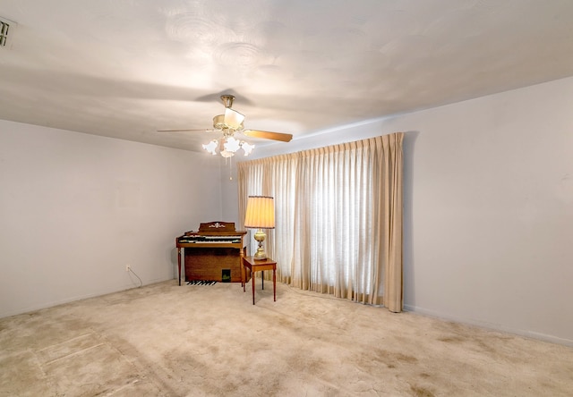 unfurnished room with ceiling fan and carpet floors