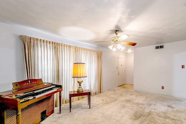 misc room featuring light colored carpet and ceiling fan