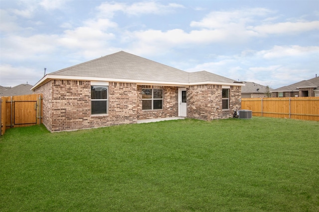 rear view of property featuring a yard