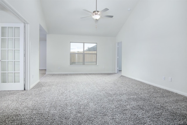 carpeted empty room with high vaulted ceiling and ceiling fan