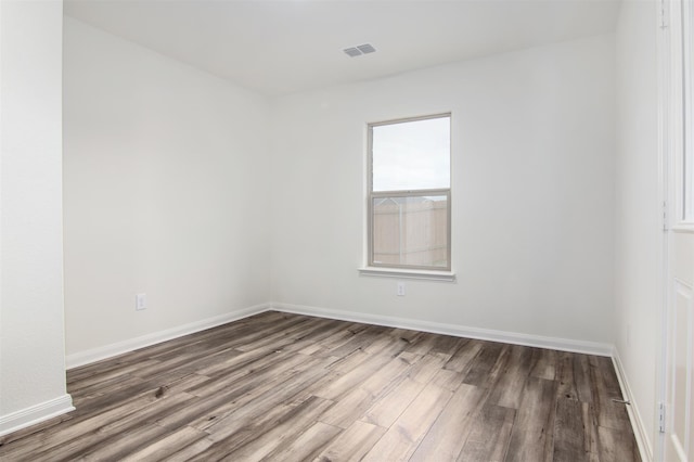 empty room with dark hardwood / wood-style floors