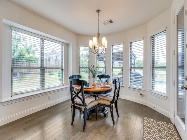 dining room featuring a notable chandelier, dark hardwood / wood-style floors, and a wealth of natural light