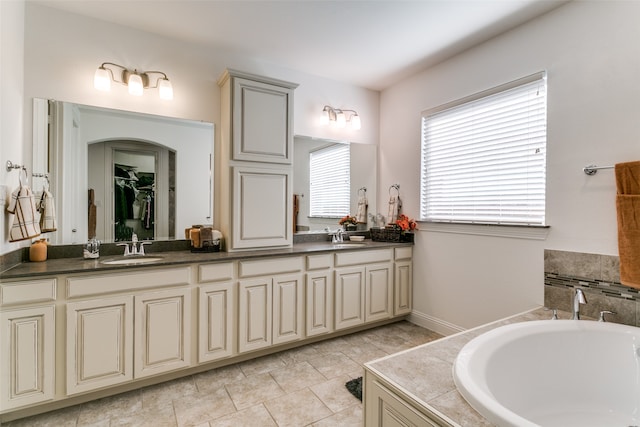 bathroom with vanity and a tub to relax in