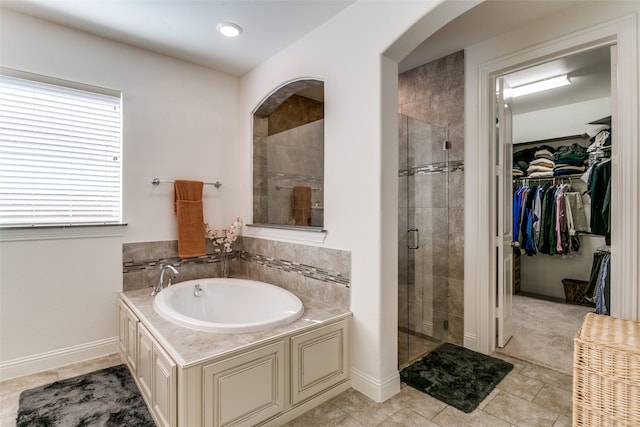 bathroom with tile patterned floors and independent shower and bath