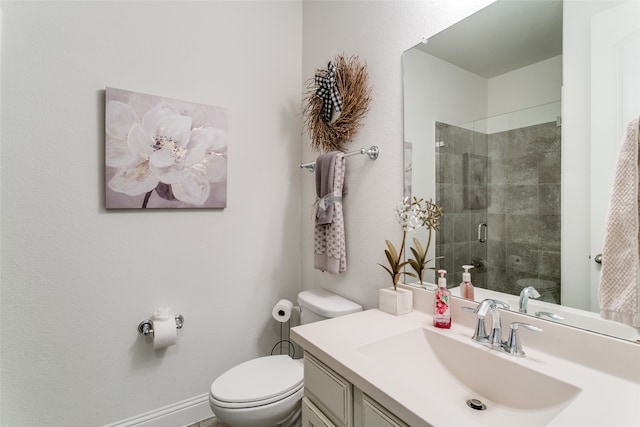 bathroom featuring vanity, an enclosed shower, and toilet