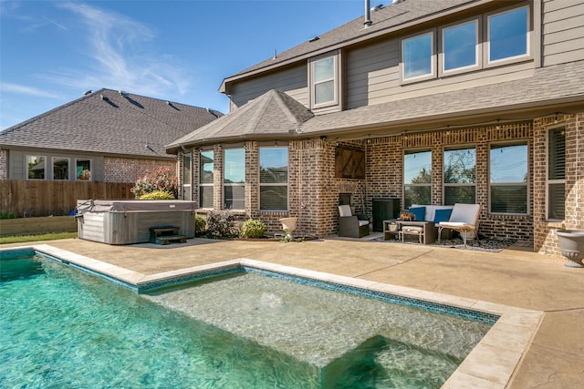 rear view of house featuring a patio, an outdoor hangout area, and a pool with hot tub