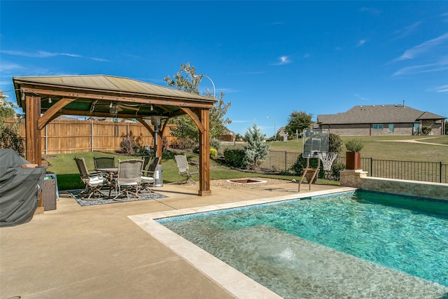 view of pool with a gazebo, a patio, a fire pit, and a yard