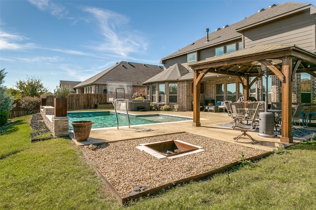 view of swimming pool with a fire pit, a patio area, and a yard