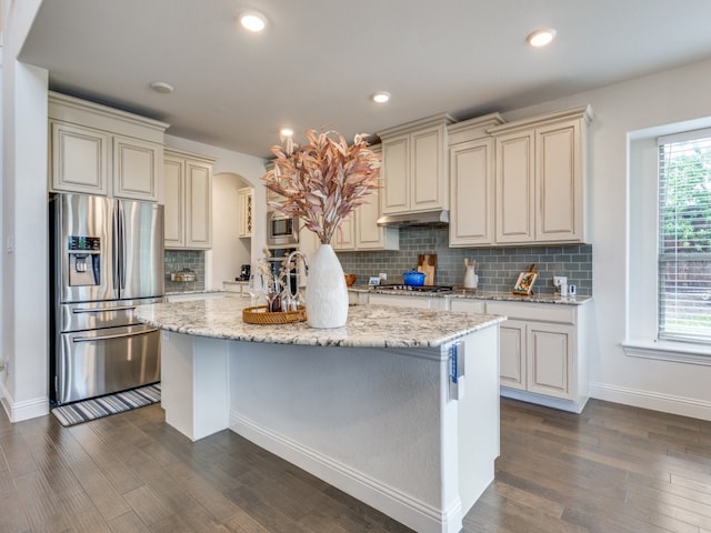 kitchen featuring stainless steel appliances, dark hardwood / wood-style floors, and cream cabinetry