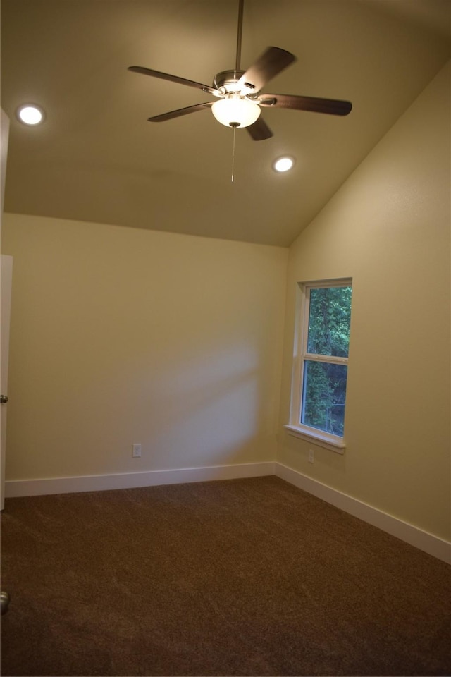 carpeted spare room with ceiling fan and vaulted ceiling