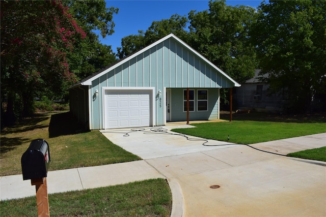 view of front of home with a garage, a front lawn, concrete driveway, and board and batten siding