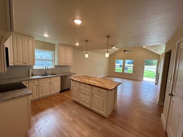 kitchen with stainless steel dishwasher, pendant lighting, a center island, light hardwood / wood-style floors, and lofted ceiling