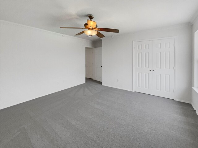 carpeted empty room with crown molding and ceiling fan