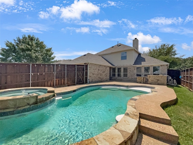 view of pool with an in ground hot tub