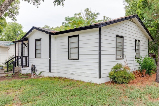 view of property exterior featuring a lawn