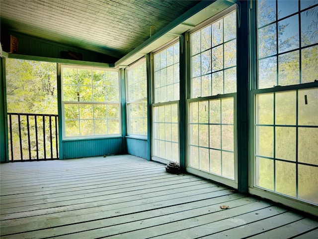 unfurnished sunroom featuring vaulted ceiling and wood ceiling