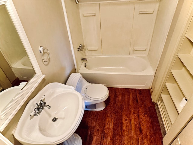 full bathroom featuring toilet, hardwood / wood-style flooring, sink, and bathing tub / shower combination