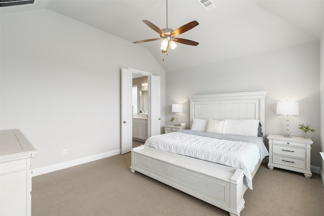 bedroom featuring lofted ceiling, light carpet, ensuite bathroom, and ceiling fan