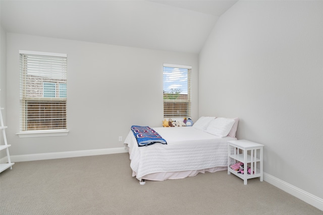 bedroom with carpet flooring and vaulted ceiling