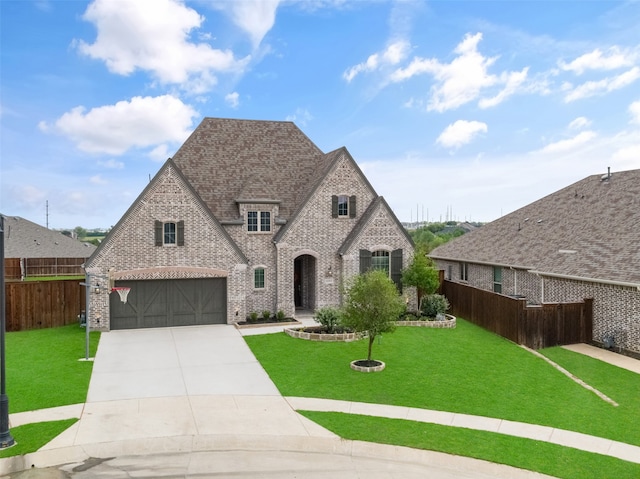 view of front of property with a front lawn and a garage