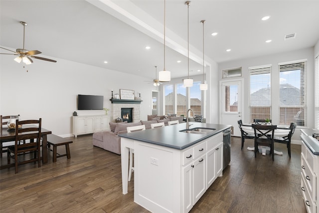 kitchen featuring ceiling fan, sink, a center island with sink, dark wood-type flooring, and white cabinetry