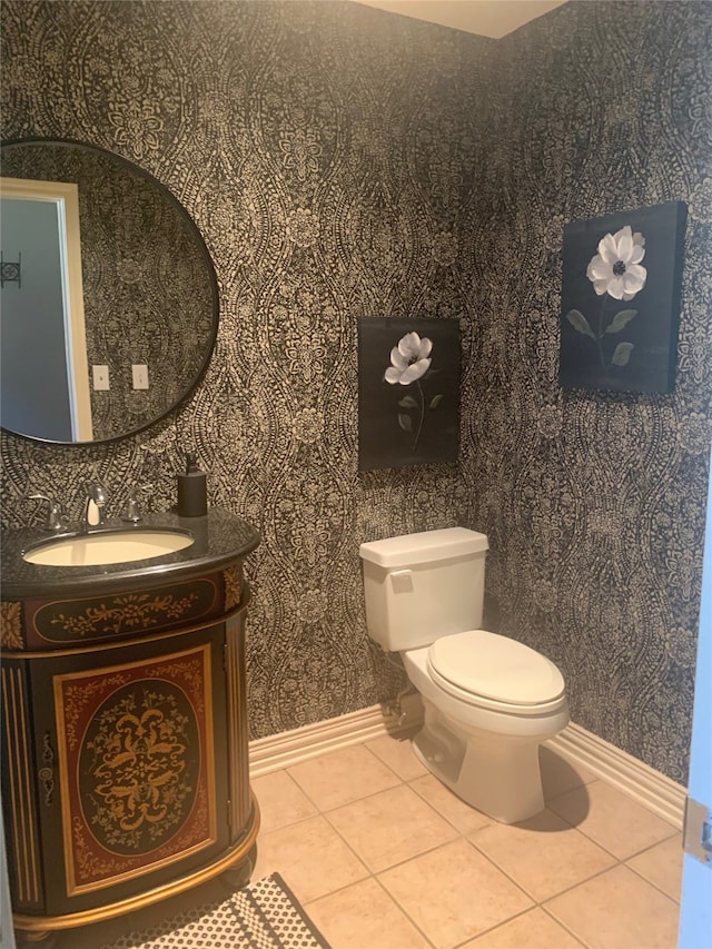 bathroom with vanity, toilet, and tile patterned floors