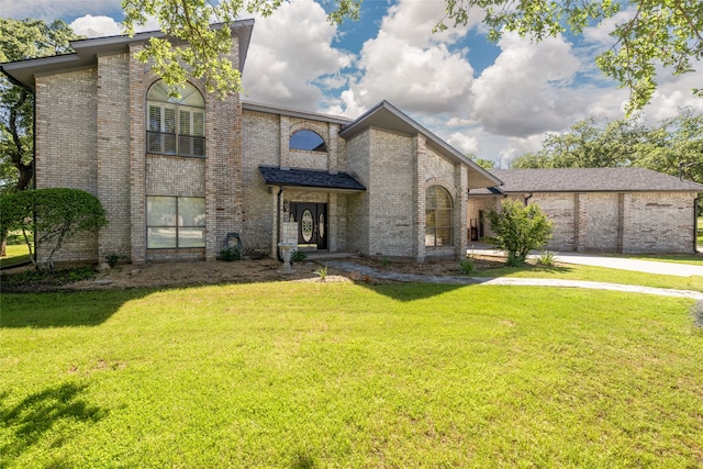 view of front of property with a front yard and a garage