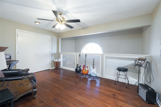 interior space with dark wood-type flooring, ceiling fan, and a textured ceiling