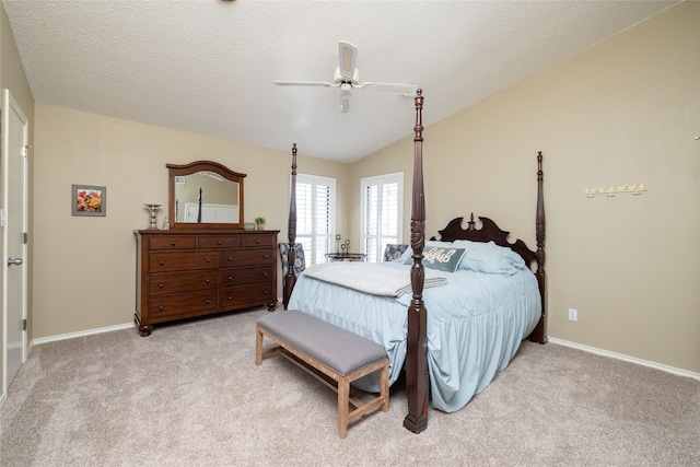 carpeted bedroom featuring lofted ceiling, ceiling fan, and a textured ceiling