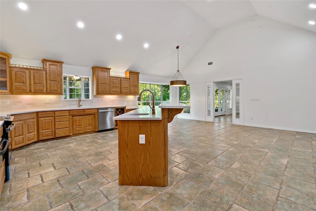 kitchen with pendant lighting, sink, stainless steel dishwasher, a kitchen island with sink, and a kitchen breakfast bar