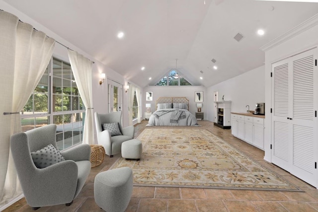 bedroom featuring a fireplace, sink, and high vaulted ceiling