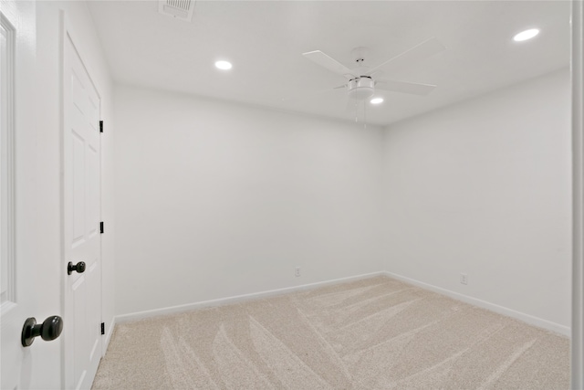 spare room featuring ceiling fan and light colored carpet