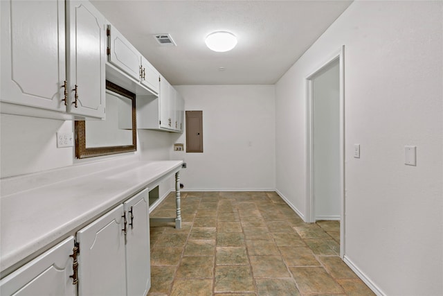 laundry room with cabinets and electric panel