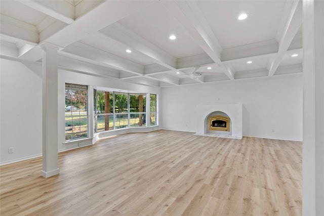 unfurnished living room featuring coffered ceiling, beamed ceiling, crown molding, and light hardwood / wood-style floors