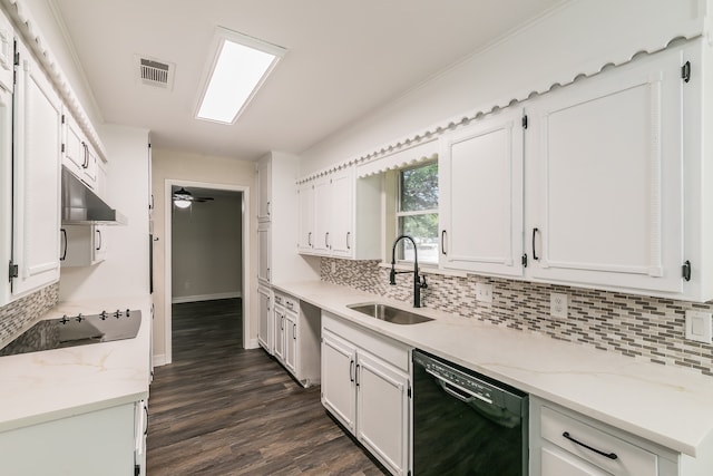 kitchen featuring white cabinets, black dishwasher, dark hardwood / wood-style flooring, sink, and light stone counters