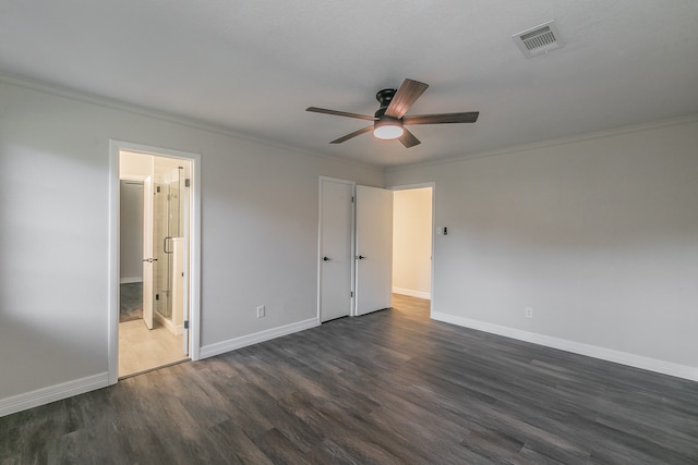 unfurnished bedroom featuring ceiling fan, connected bathroom, crown molding, and dark hardwood / wood-style flooring