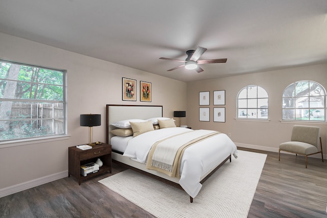 bedroom with ceiling fan and dark hardwood / wood-style floors