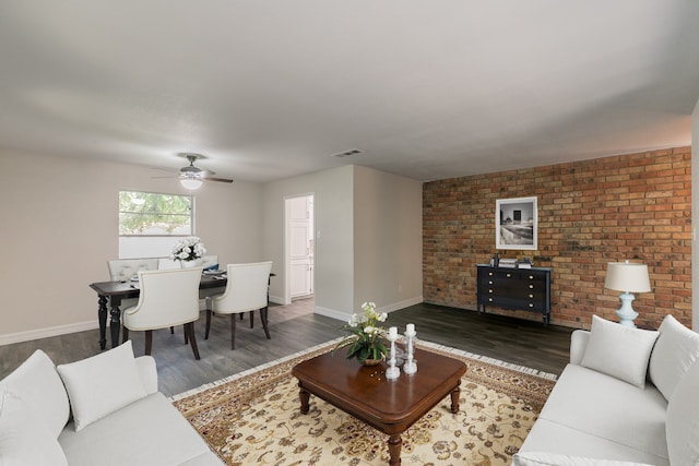 living room featuring ceiling fan and dark hardwood / wood-style floors