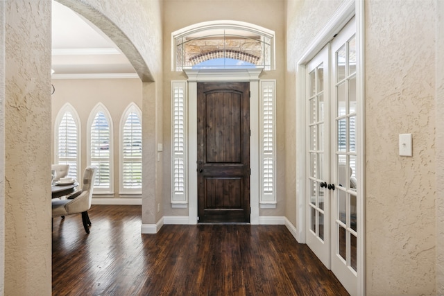 entryway with crown molding, french doors, and dark hardwood / wood-style floors