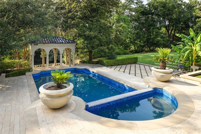 view of swimming pool with a patio area and a gazebo