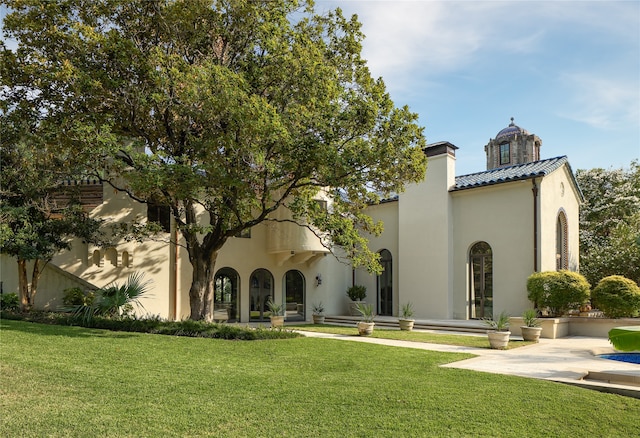 rear view of house with a yard and a patio area