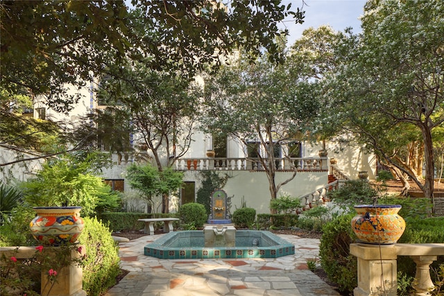 view of home's community with a patio area